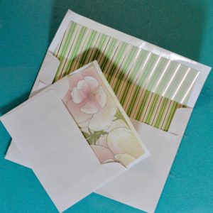 diy wedding stationery envelope liners green and gold stripes with pink flowers